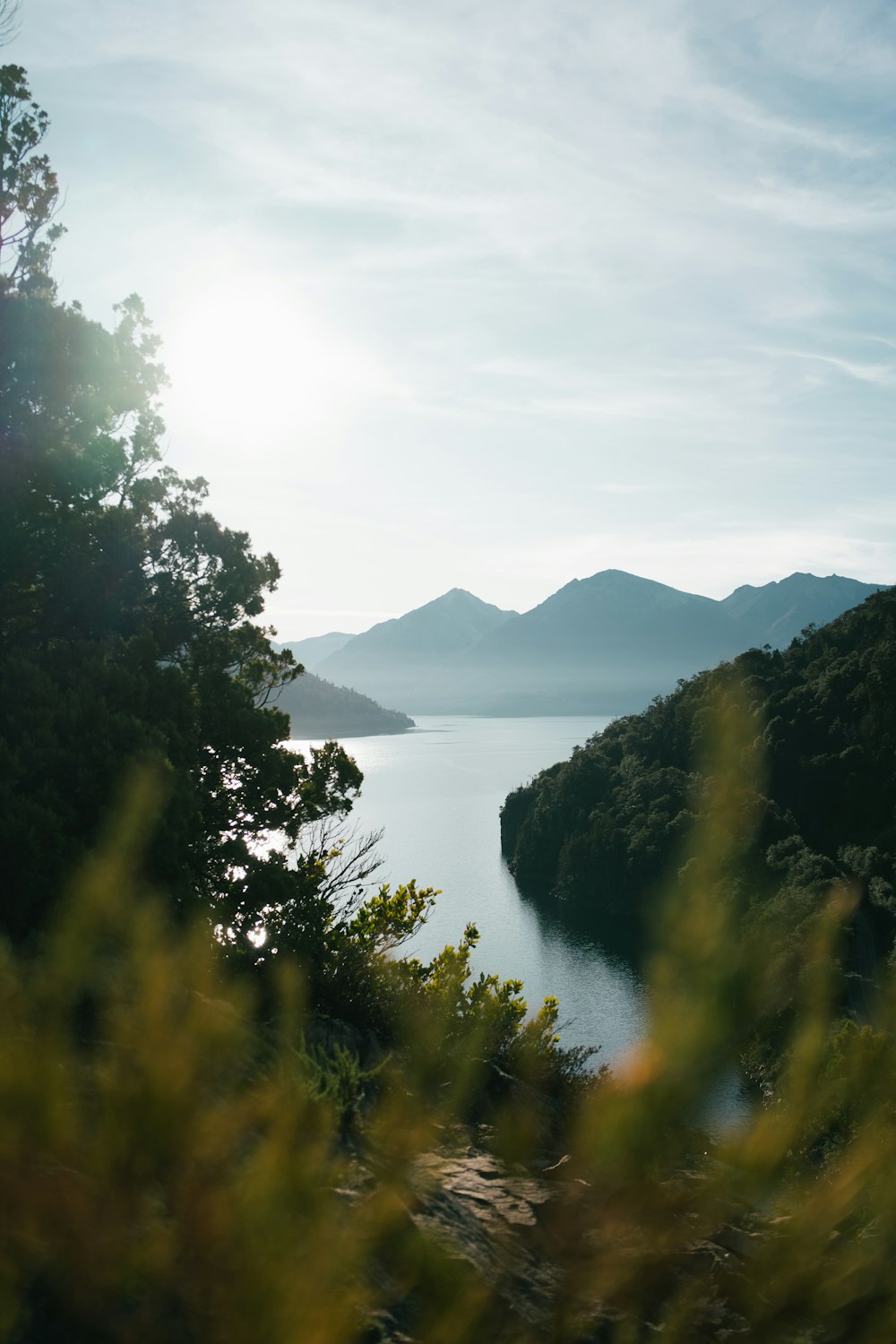 a view of a body of water with mountains in the background