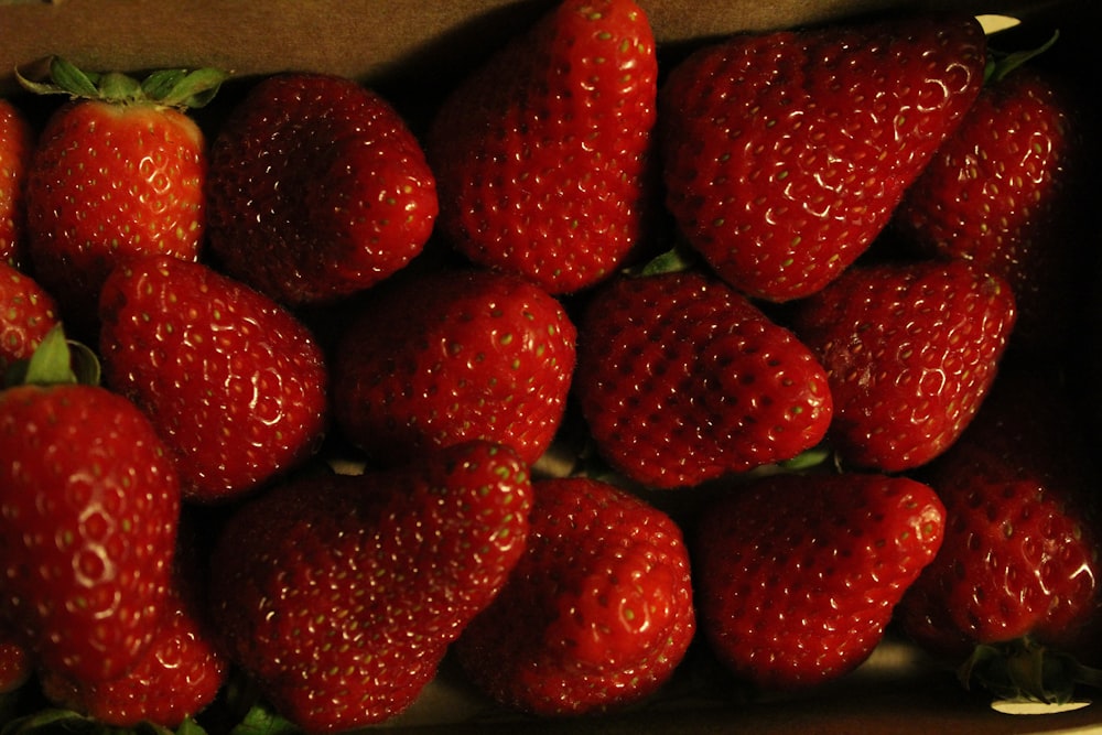 a bunch of strawberries in a cardboard box