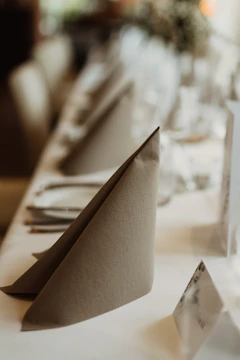 A restaurant kitchen with clean tablecloths and napkins.
