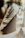 Close-up of elegant embroidered dinner napkins folded neatly on a rustic wooden table.