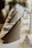 Close-up of elegant embroidered dinner napkins folded neatly on a rustic wooden table.