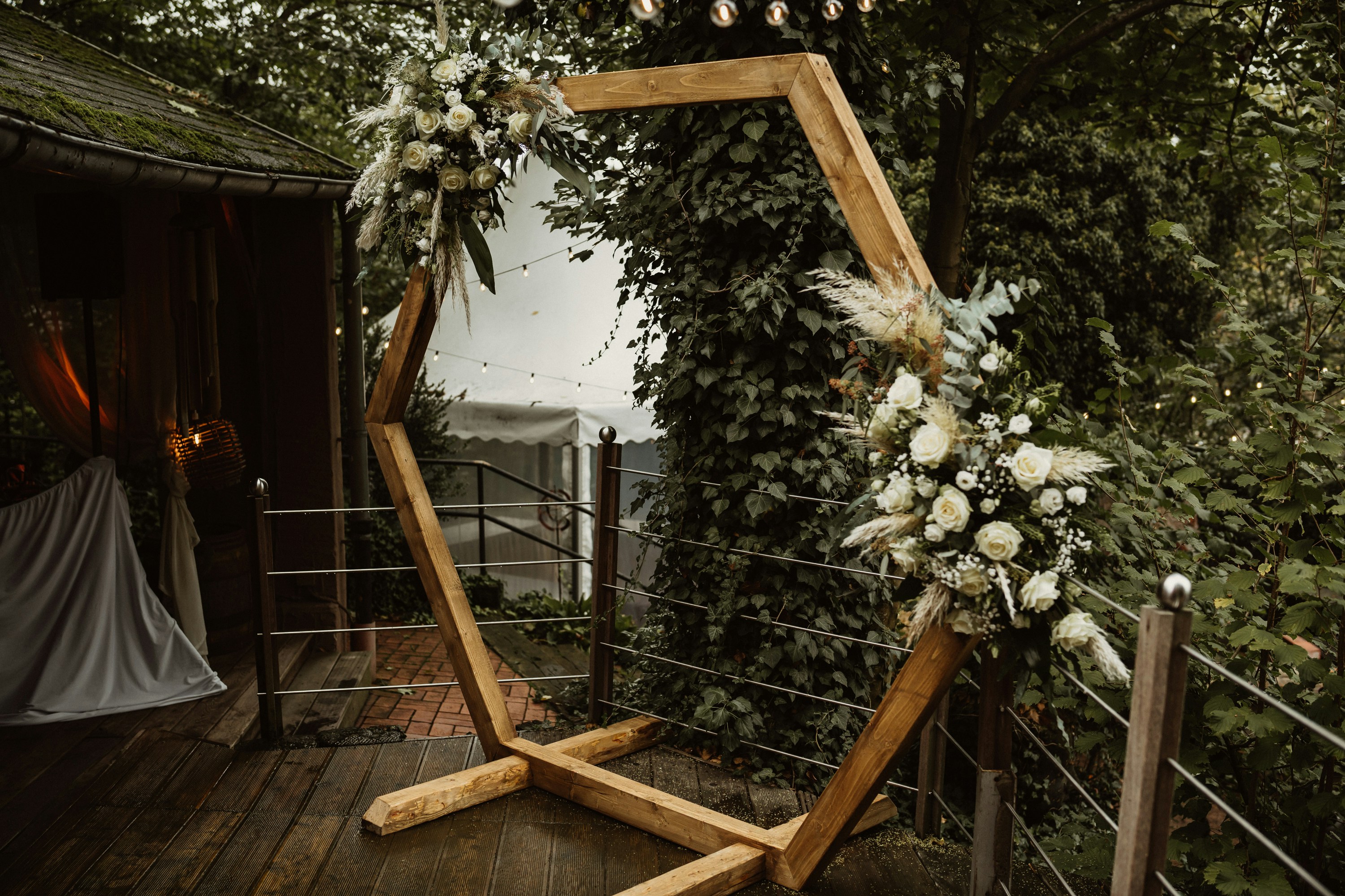 a wooden frame decorated with flowers and greenery