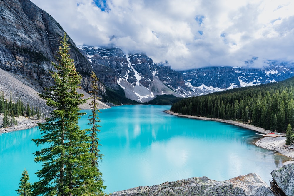 a blue lake surrounded by mountains and trees