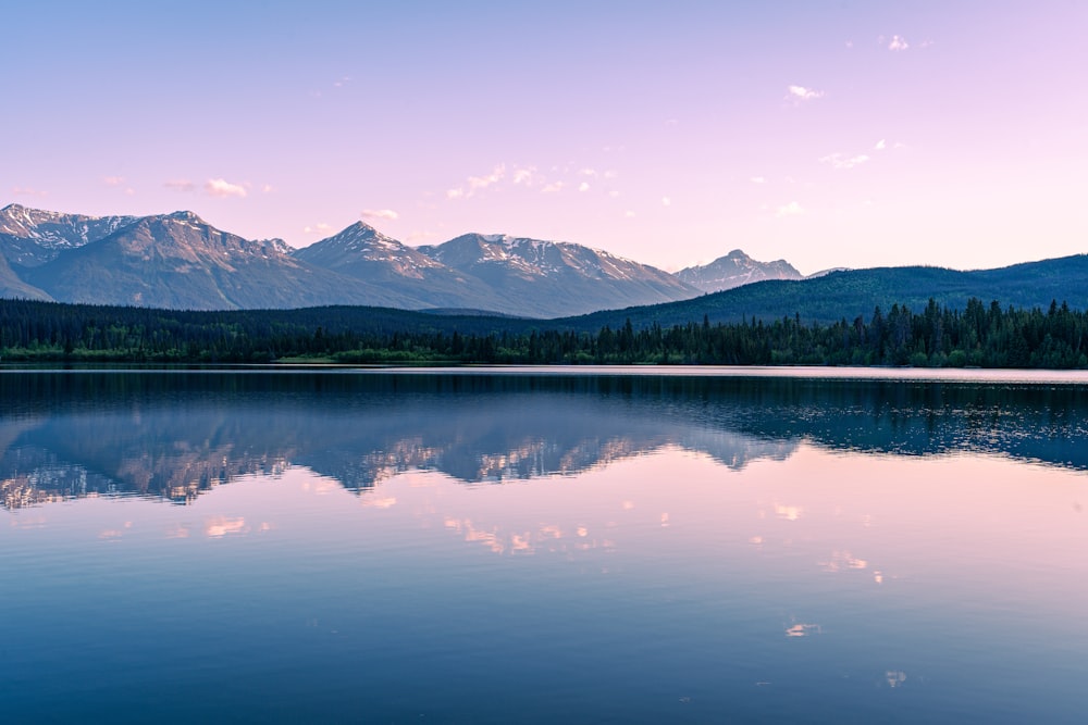 a lake with mountains in the background