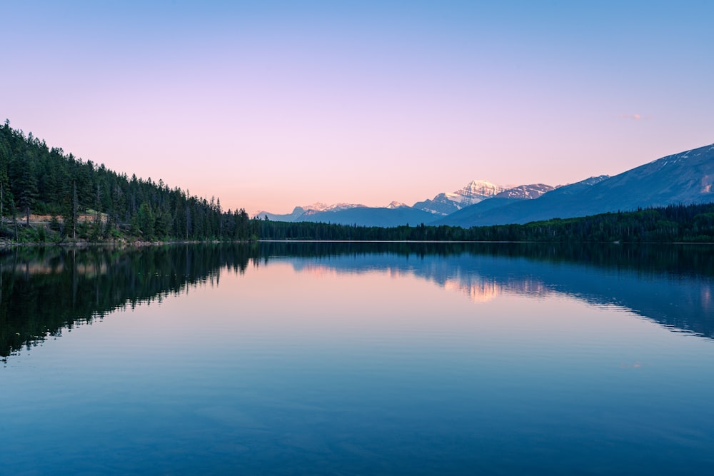 a lake with mountains in the background