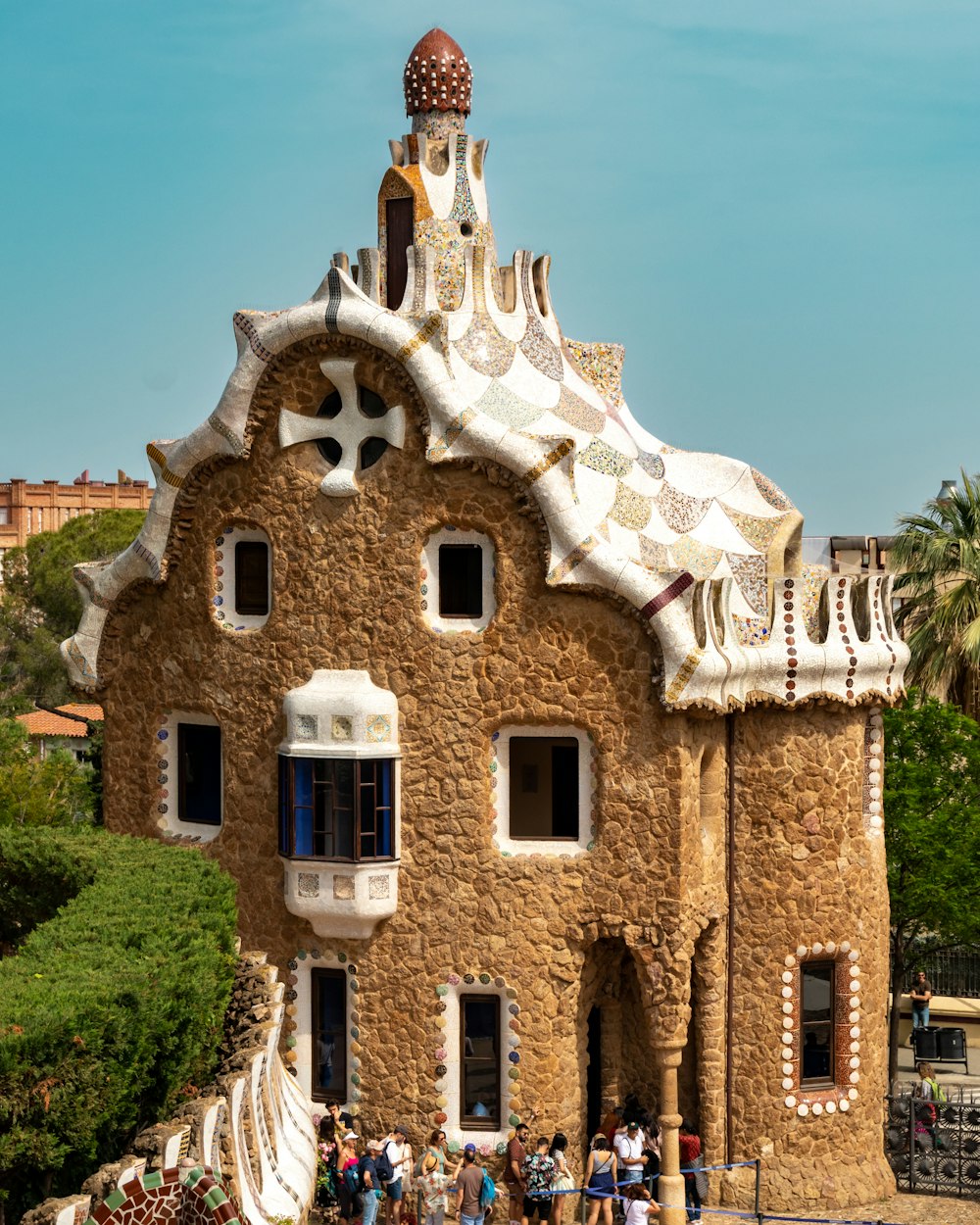 a building made of rocks with people standing in front of it