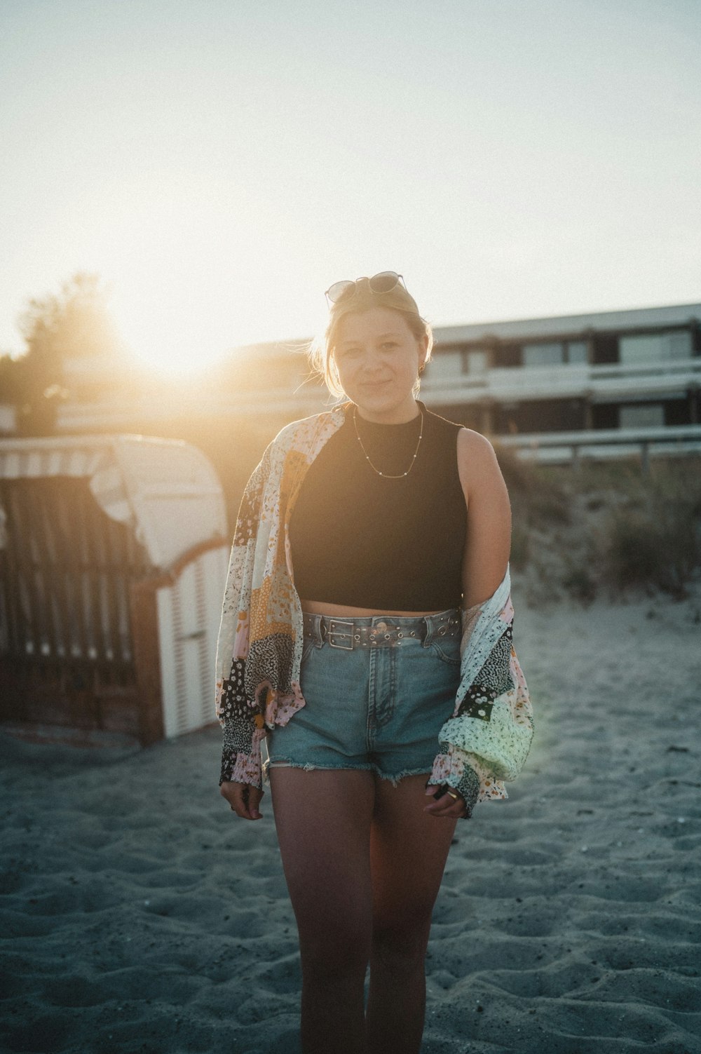 a woman standing on top of a sandy beach