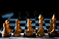 Close-up of elegant chess pieces arranged on a classic wooden board.