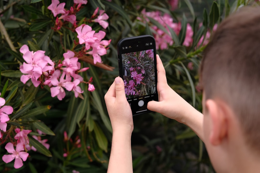 a person taking a picture with a cell phone