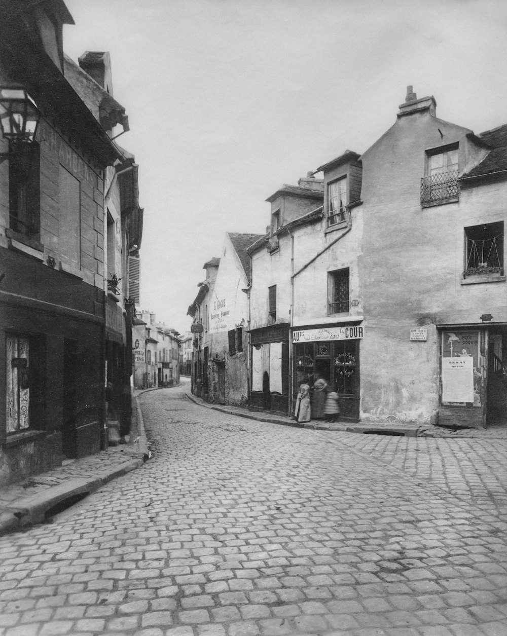 a black and white photo of a cobblestone street