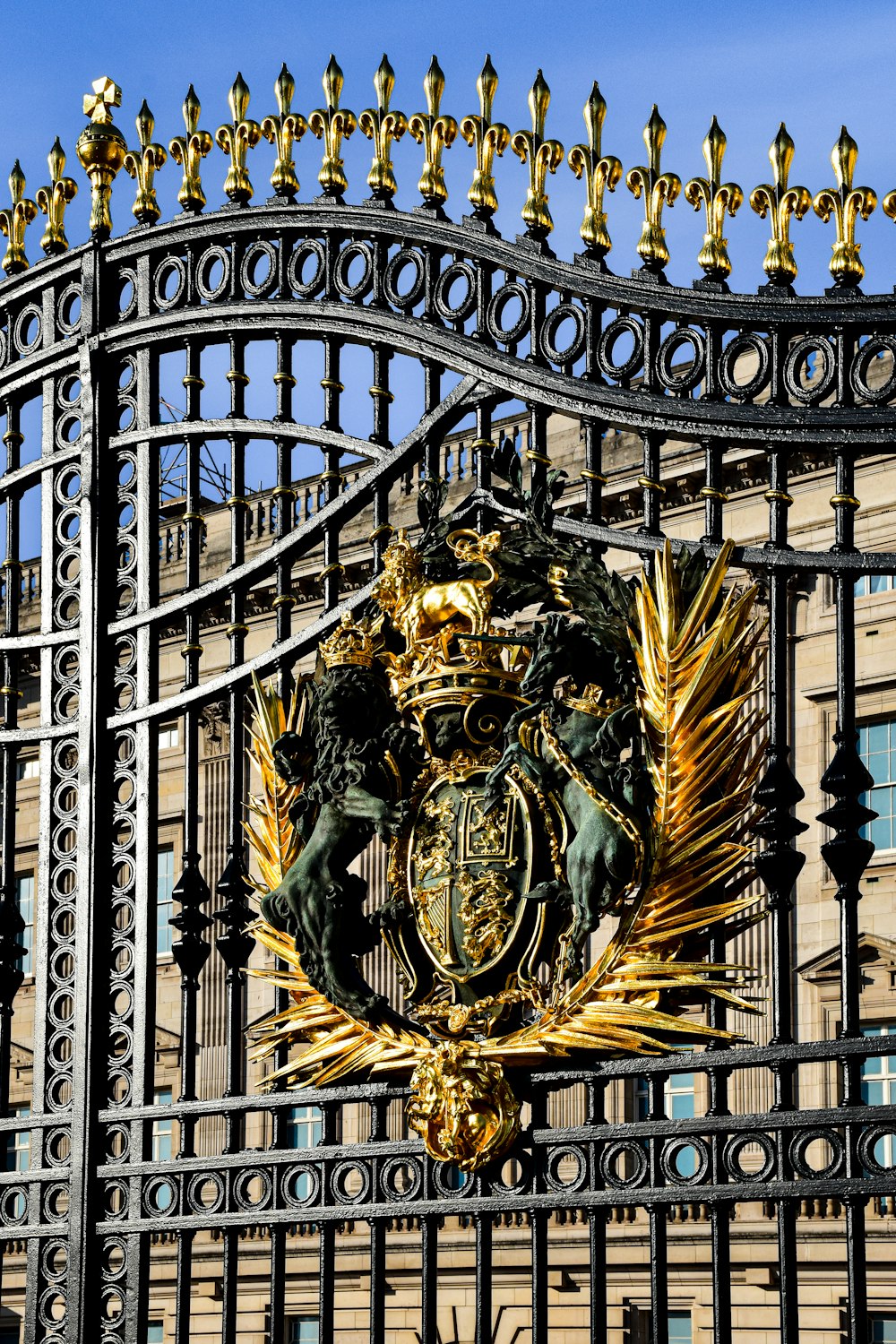 a large metal gate with a coat of arms on it