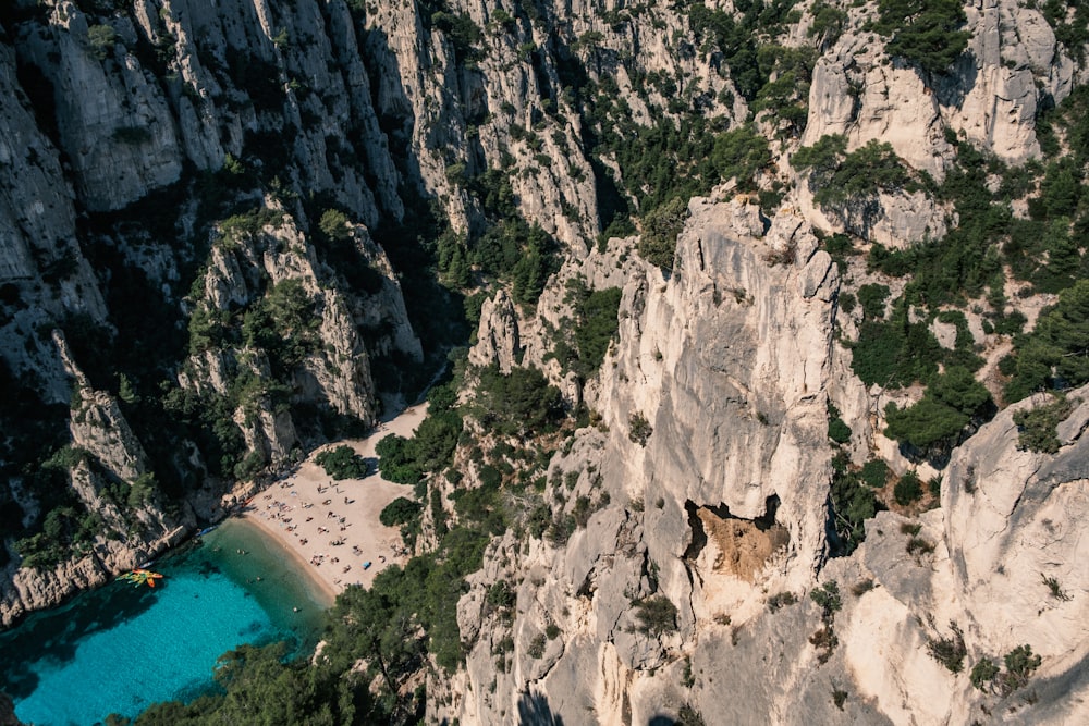 an aerial view of a rocky cliff with a lake in the middle