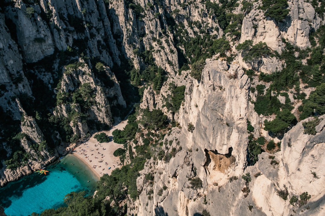 an aerial view of a rocky cliff with a lake in the middle,