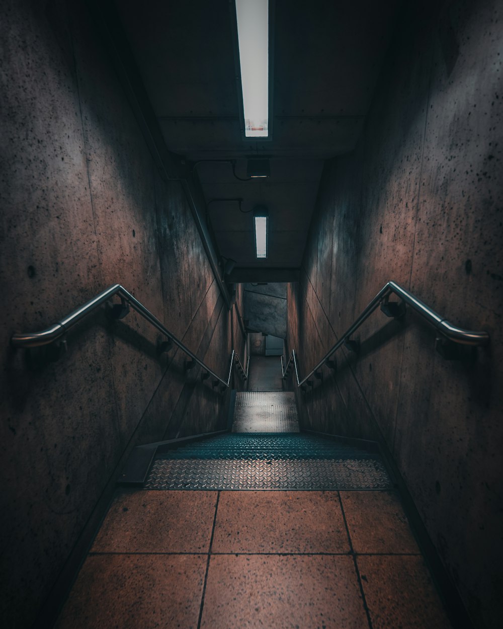 a long hallway with a metal hand rail