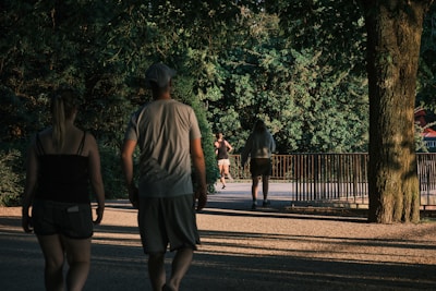 A peaceful park setting with people jogging and enjoying nature.