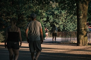 A serene landscape of a park with people exercising.