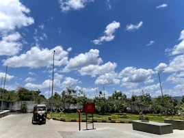 The exterior of a Doc Drop Ride vehicle parked outside a healthcare center on a sunny day.