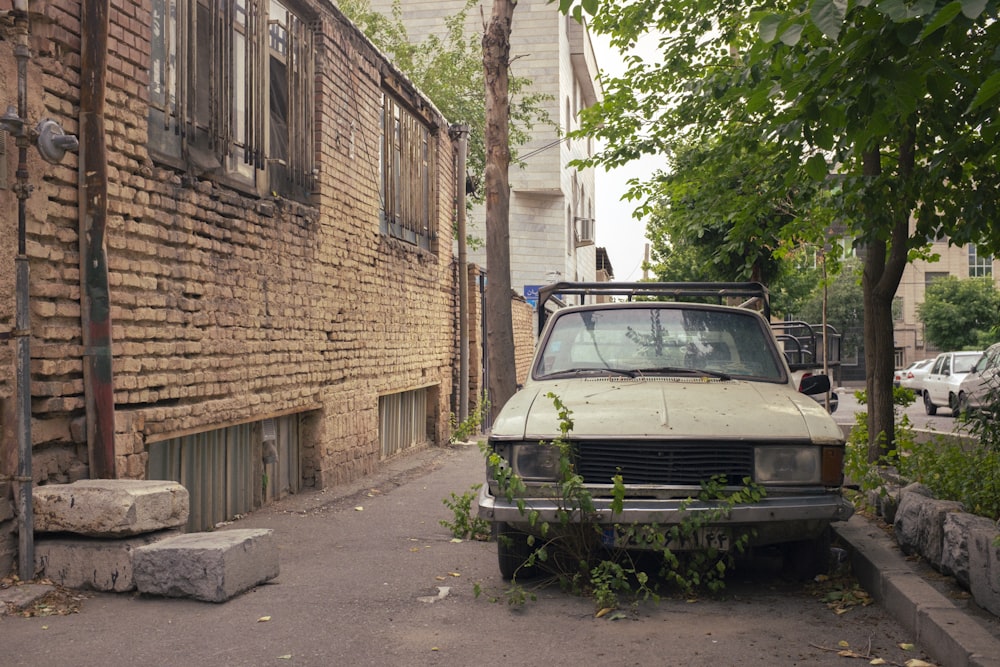 an old truck parked on the side of a street