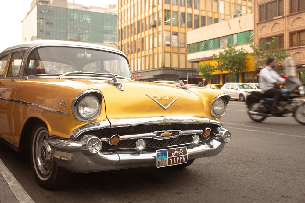 an old car is parked on the side of the road