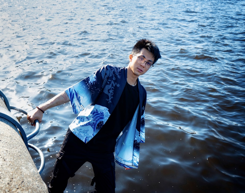 a young man is standing in the water