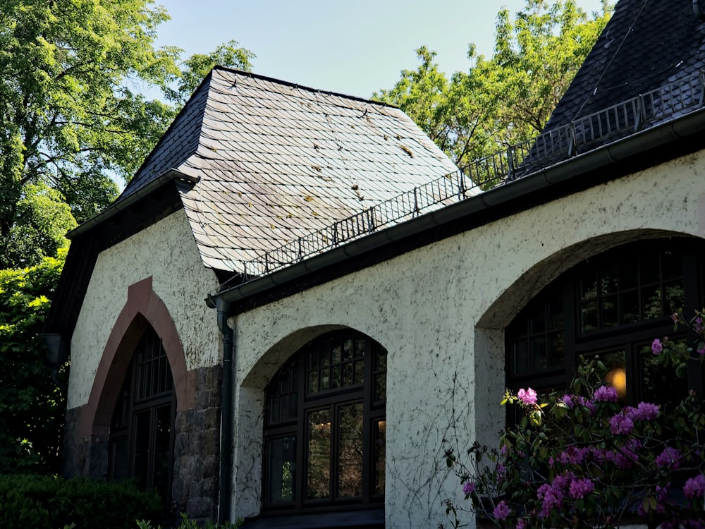 a white house with a black roof and windows