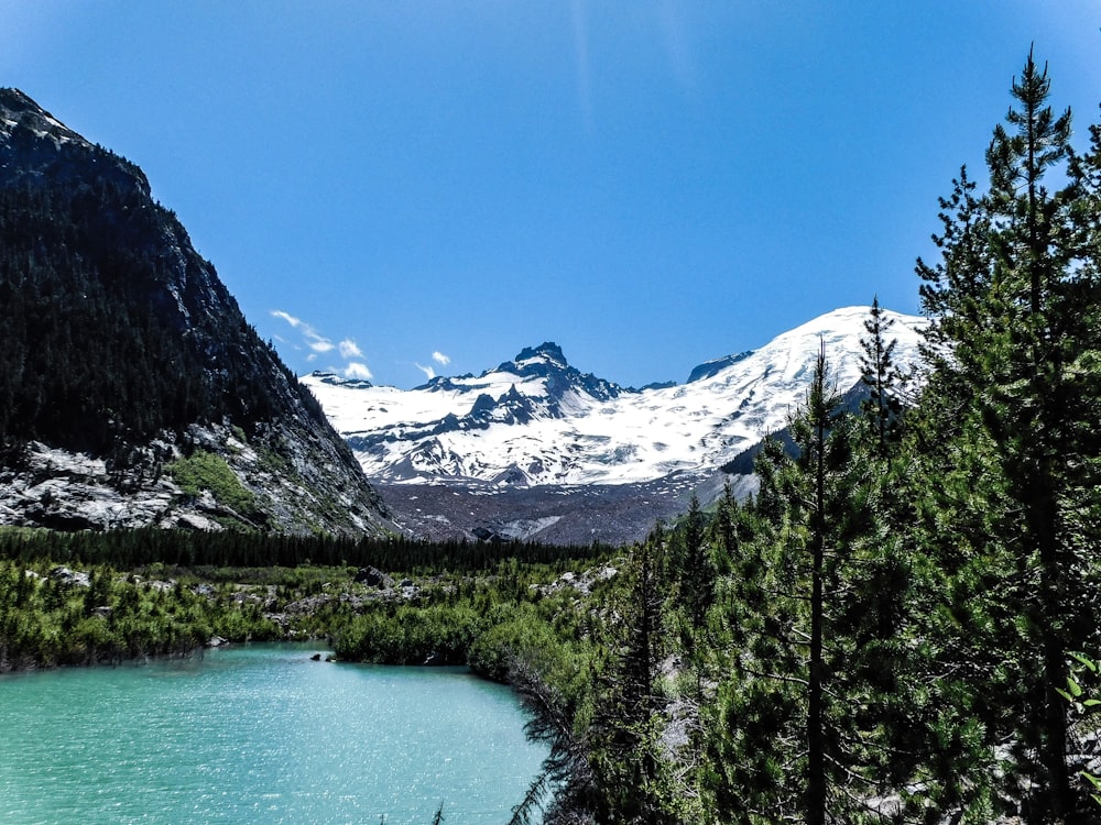 a view of a mountain range with a lake in the foreground