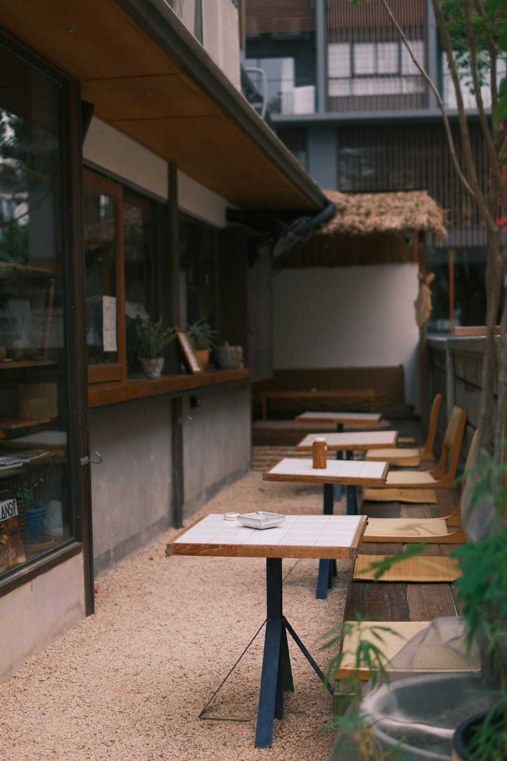 a row of wooden benches sitting outside of a building