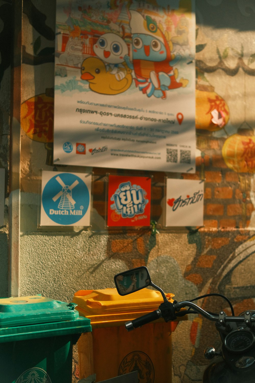 a bicycle parked in front of a wall with posters on it