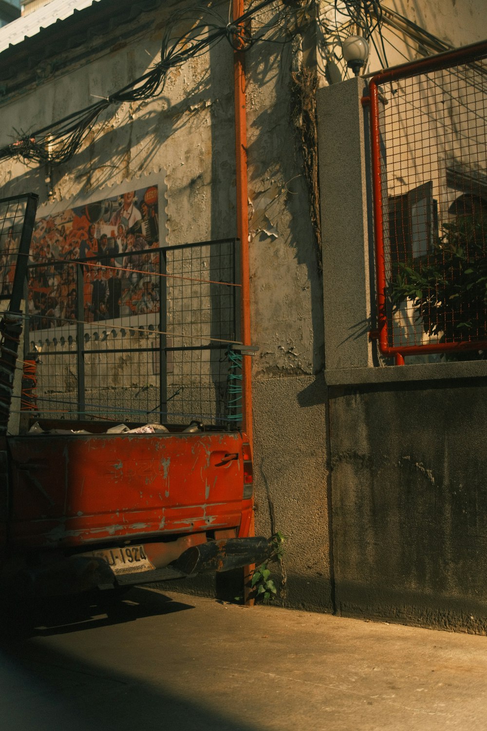 a red truck parked next to a building