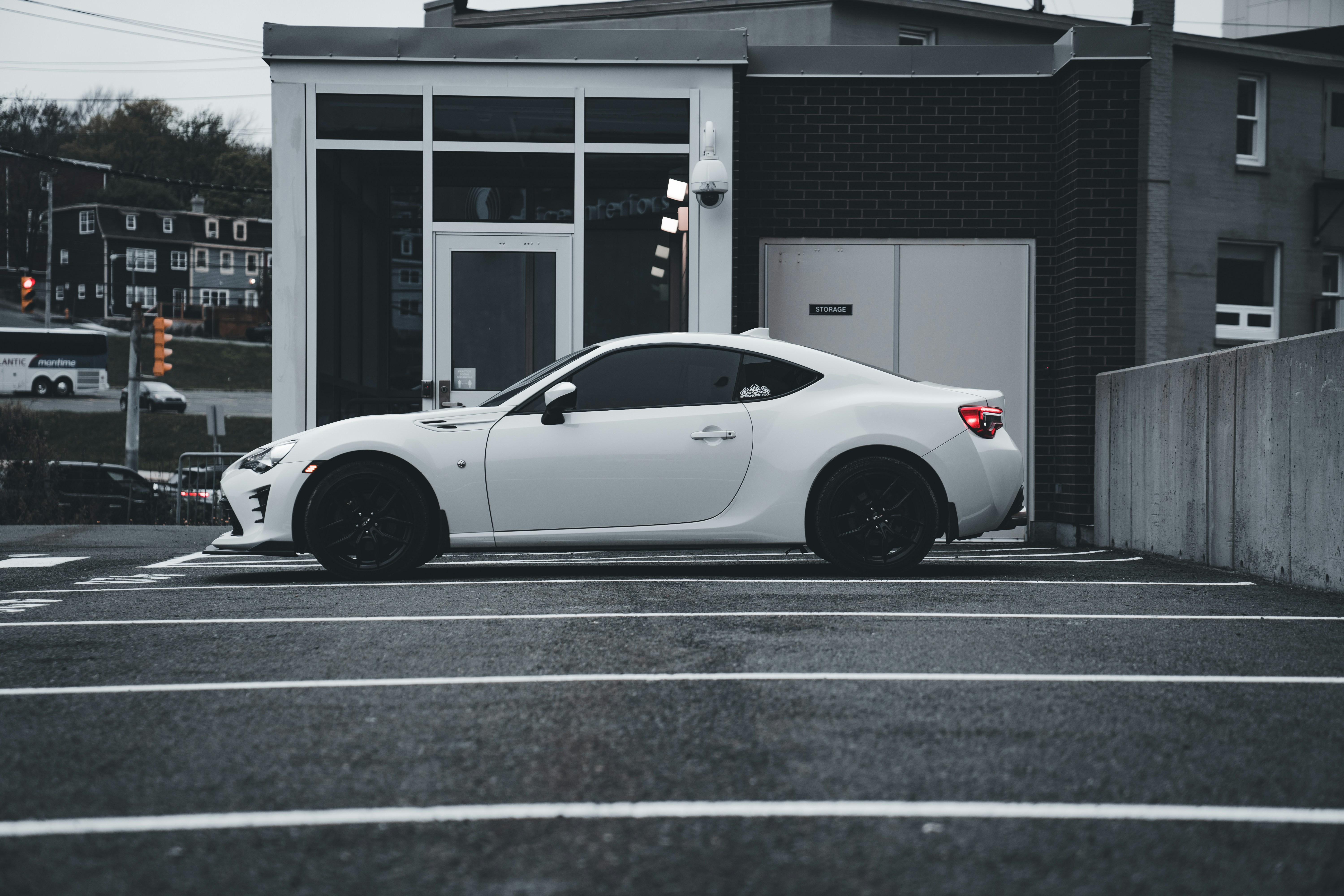 a white sports car parked in a parking lot