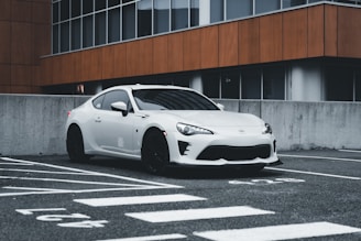 A sleek, modern car parked in an urban setting.