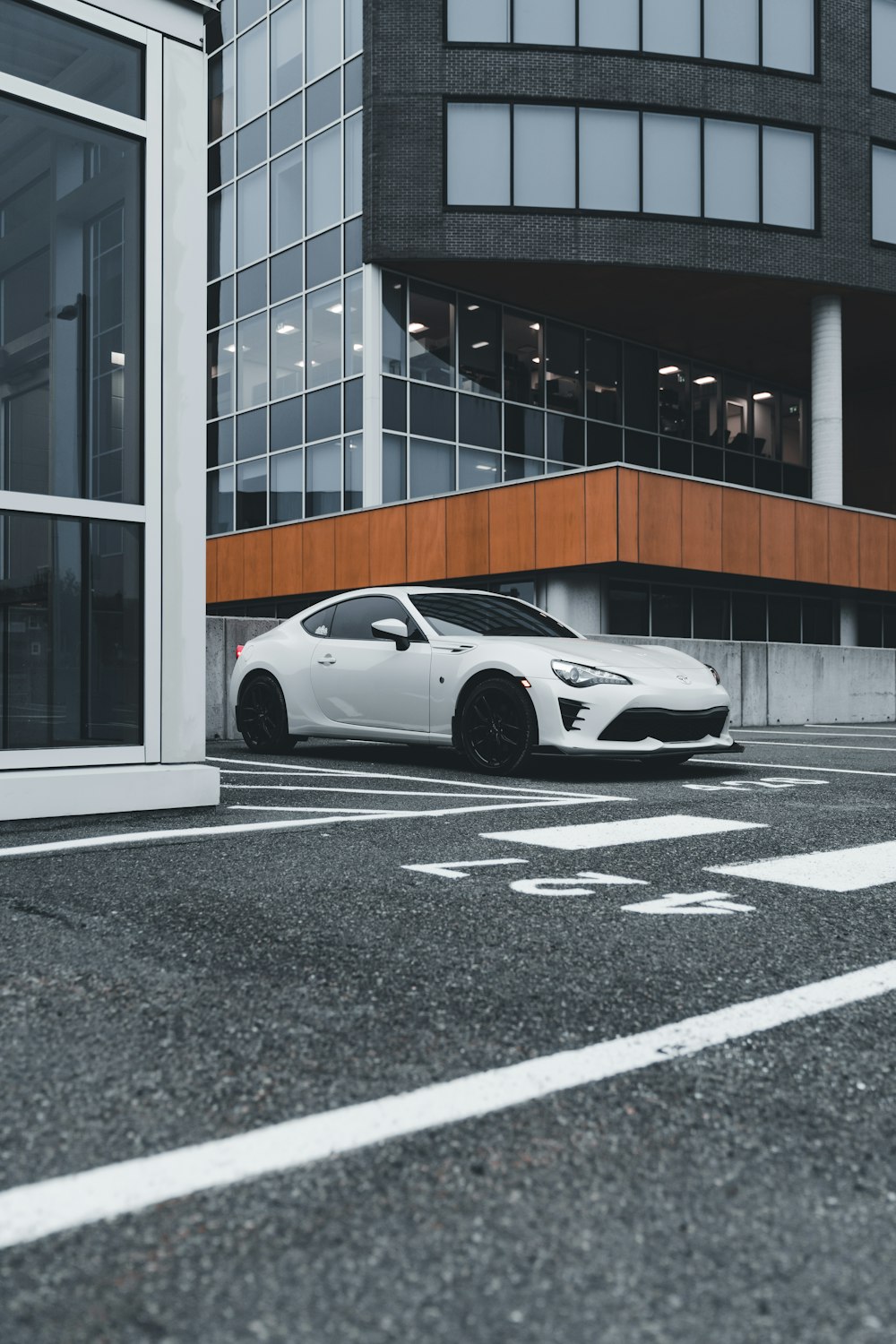 a white sports car parked in front of a building