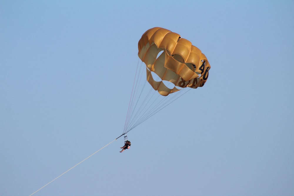 a person is parasailing in the sky with a parachute