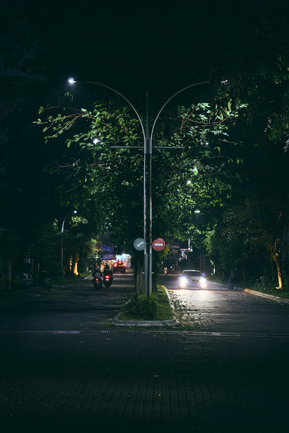 a car driving down a street at night