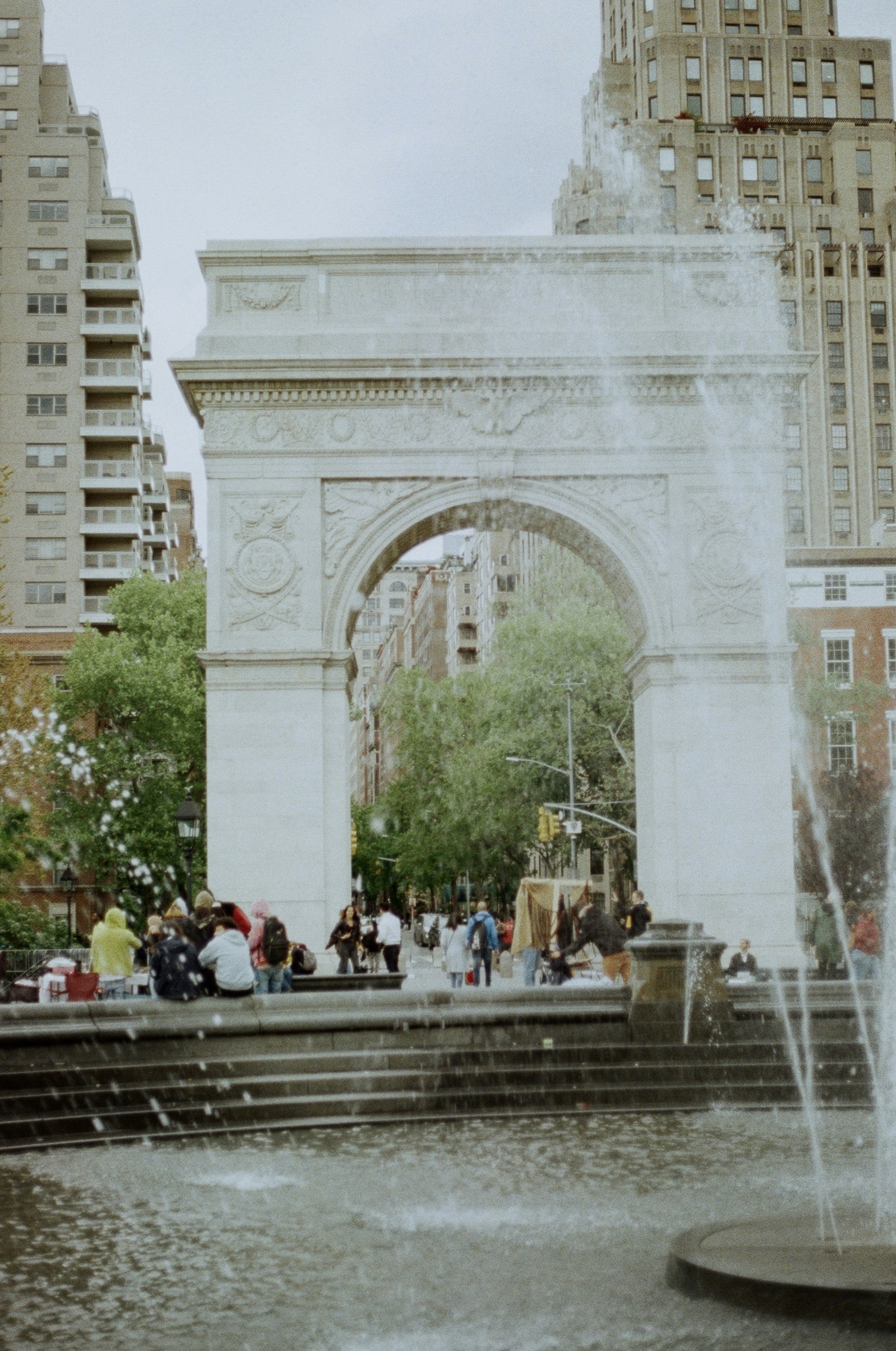 A group of people standing around a fountain
