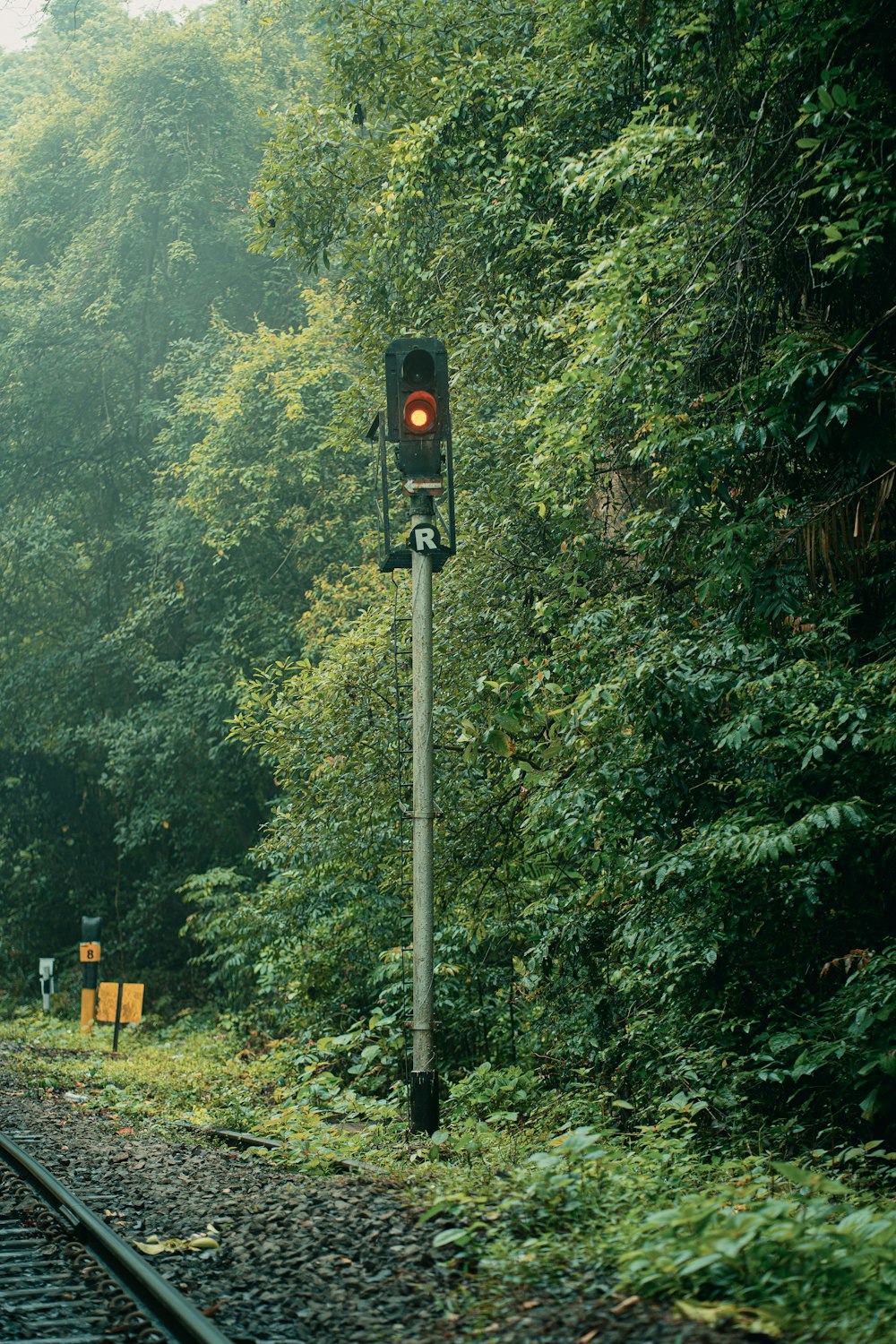 a railroad track with a red light on it