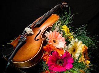 A violin surrounded by beautiful flowers at a wedding ceremony in Asheville