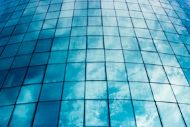 Close-up of sparkling clean windows reflecting a sunny sky