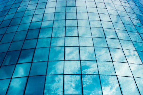 Close-up of a sparkling clean window reflecting a bright blue sky.