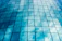 Close-up of a gleaming window reflecting a sunny blue sky after cleaning.