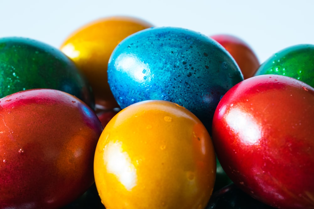 a group of colorful eggs sitting on top of each other