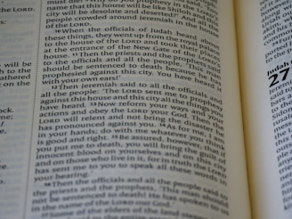 Close-up of an open ancient scripture with highlighted text.