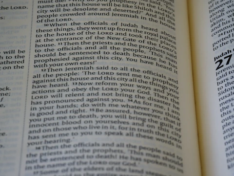 Close-up of an open book with highlighted passages on religious studies.
