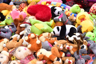 A cozy arrangement of colorful plush toys with soft textures, inviting you to touch and hug.
