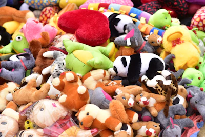 A colorful assortment of plush and chew toys scattered on a cozy pet bed.