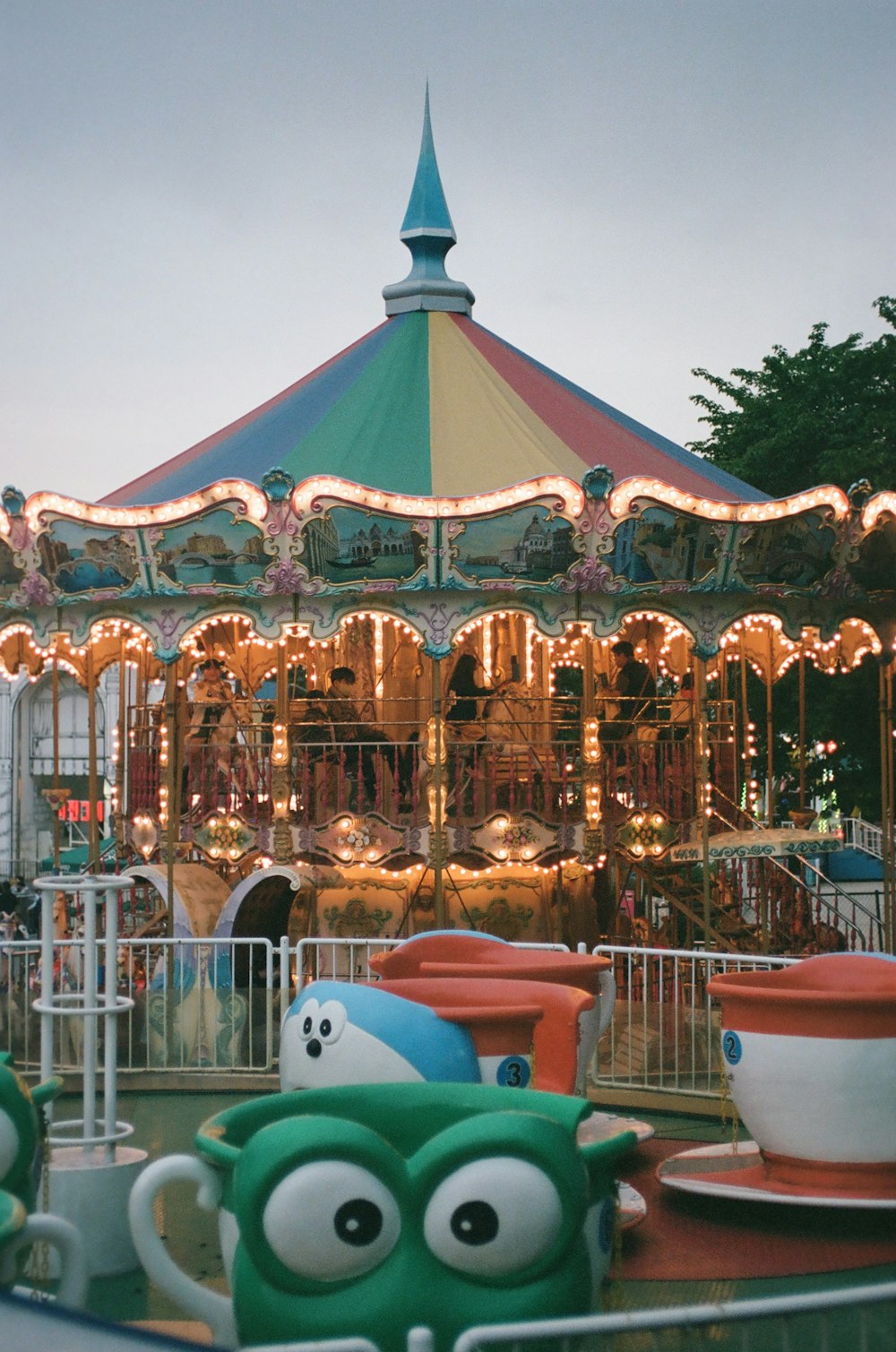 a merry go round at a carnival with lights on