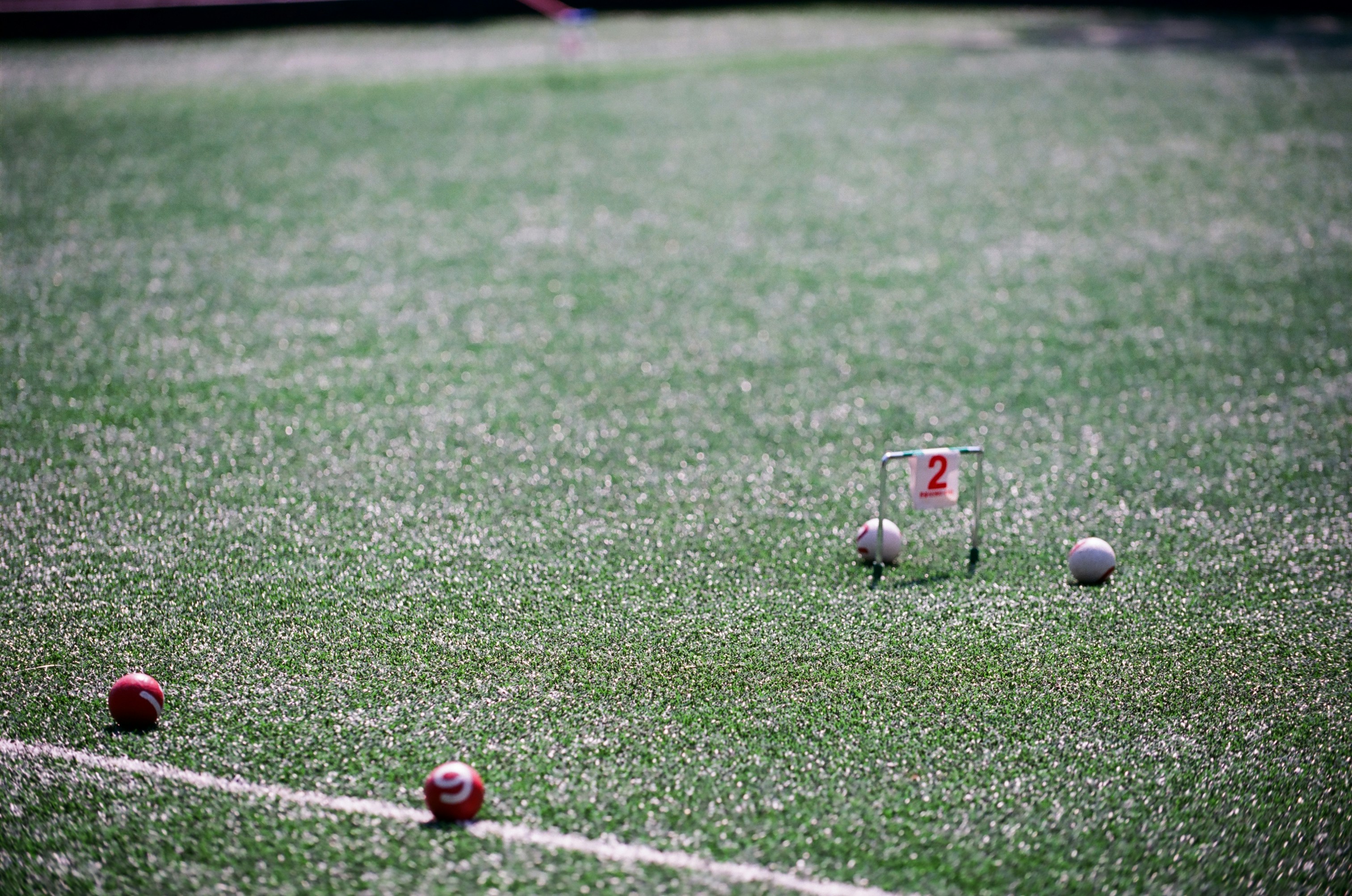 a soccer field with balls and a tee on it