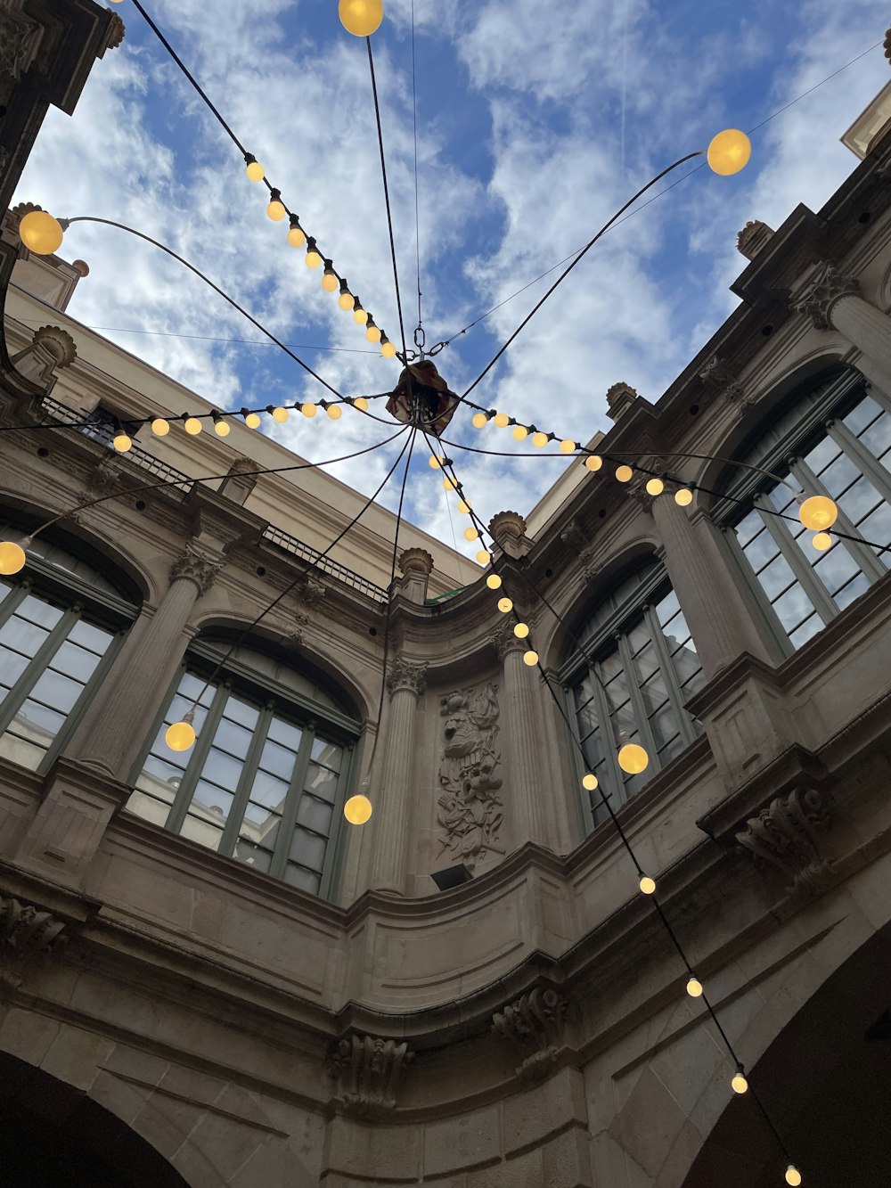 a building with a bunch of lights hanging from it's ceiling