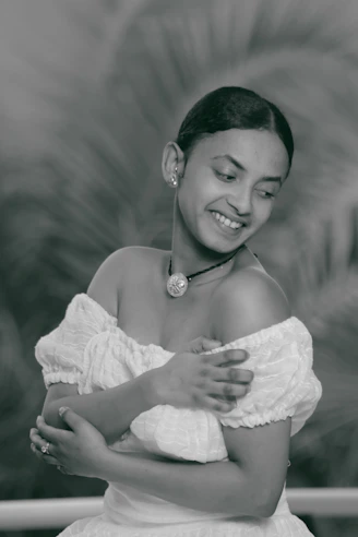 Smiling mature woman gently holding her arm, symbolizing bone strength and care.