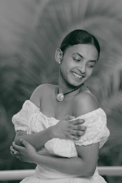 Smiling mature woman gently holding her arm, symbolizing bone strength and care.